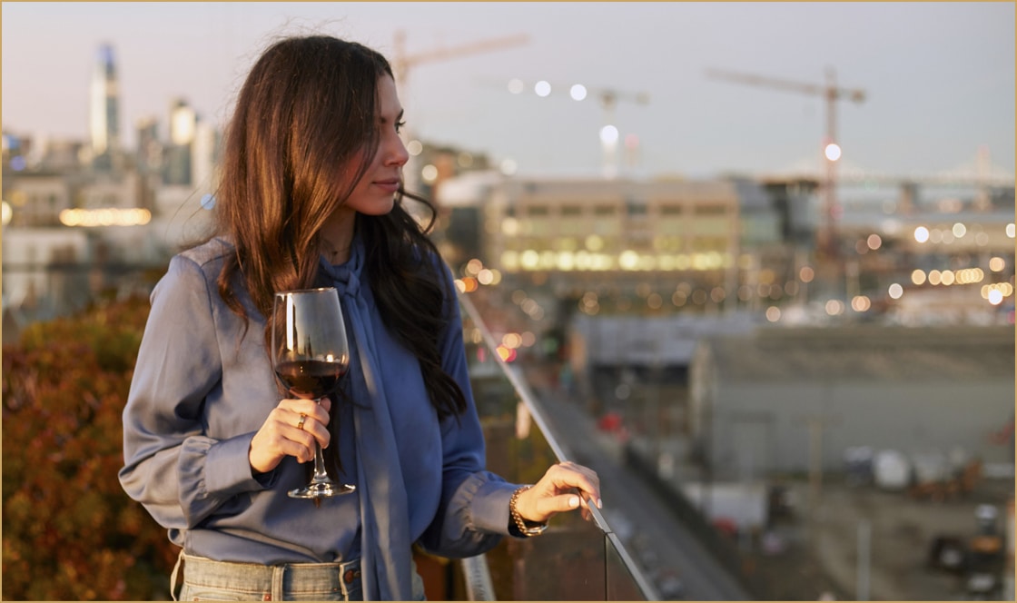 A 2177 Third Resident enjoys a glass of wine on the rooftop deck